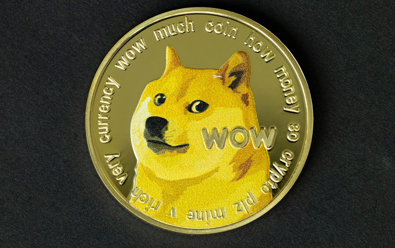Dogecoin cryptocurrency – photo of Dogecoin crypto currency physical gold coin. Symbol of the doge m