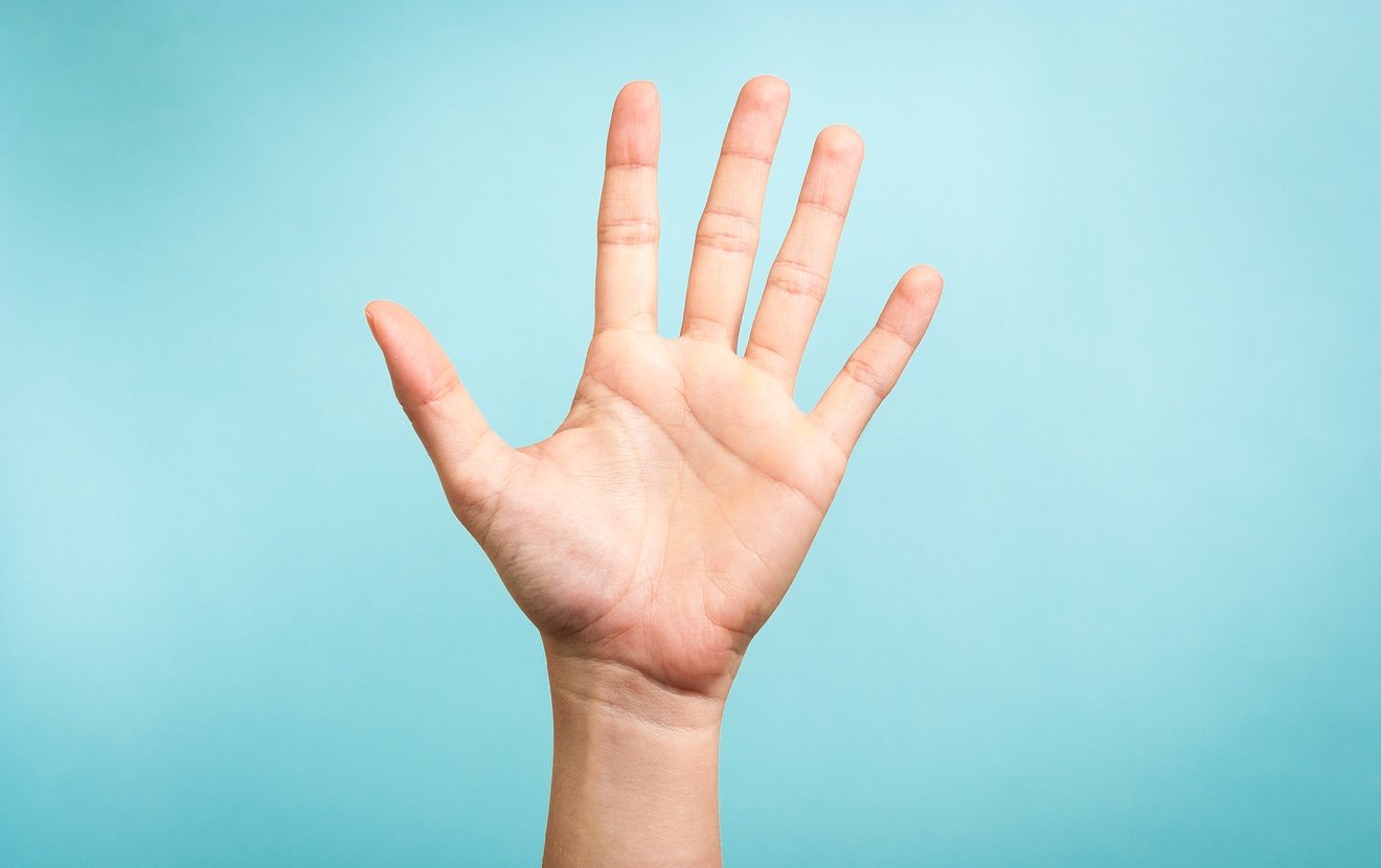 Hand up with open palm on blue background. Stop concept.