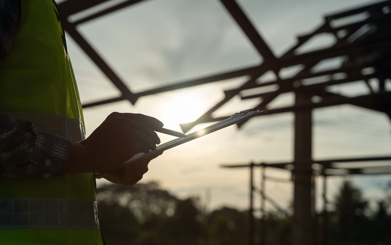 Inspector Or Engineer Is Inspecting Construction And Quality Assurance New House Using A Checklist.