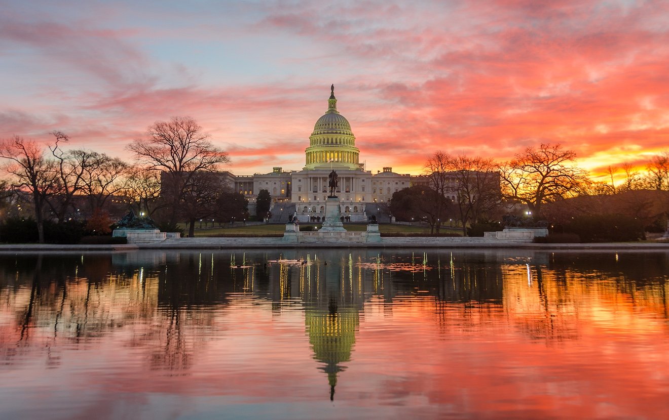 Washington DC, Capitol Building in a cloudy sunrise with mirror reflection