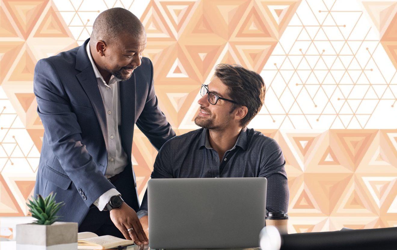 Two men in front of a laptop