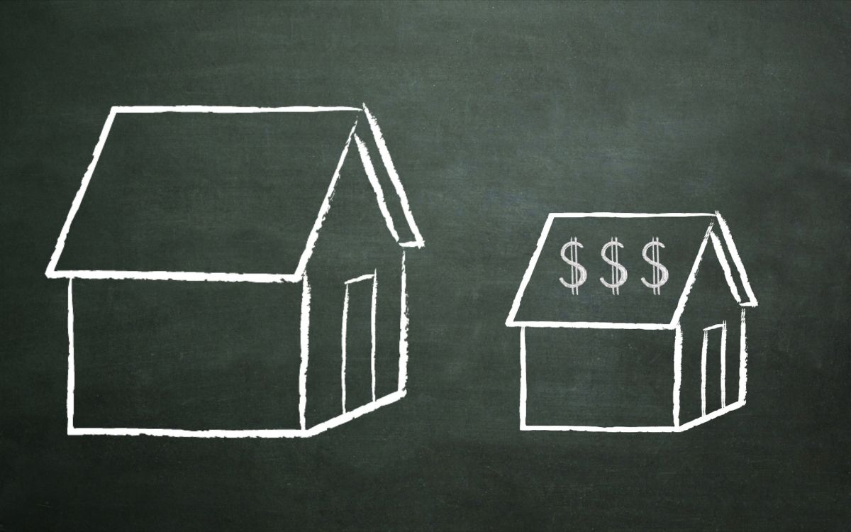 Chalkboard with big credit union and small credit union shrinking to grow